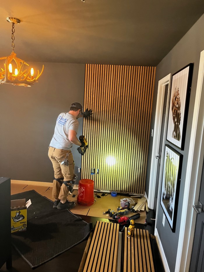 John the Handyman installing acoustic slat panels in Charlotte, NC.